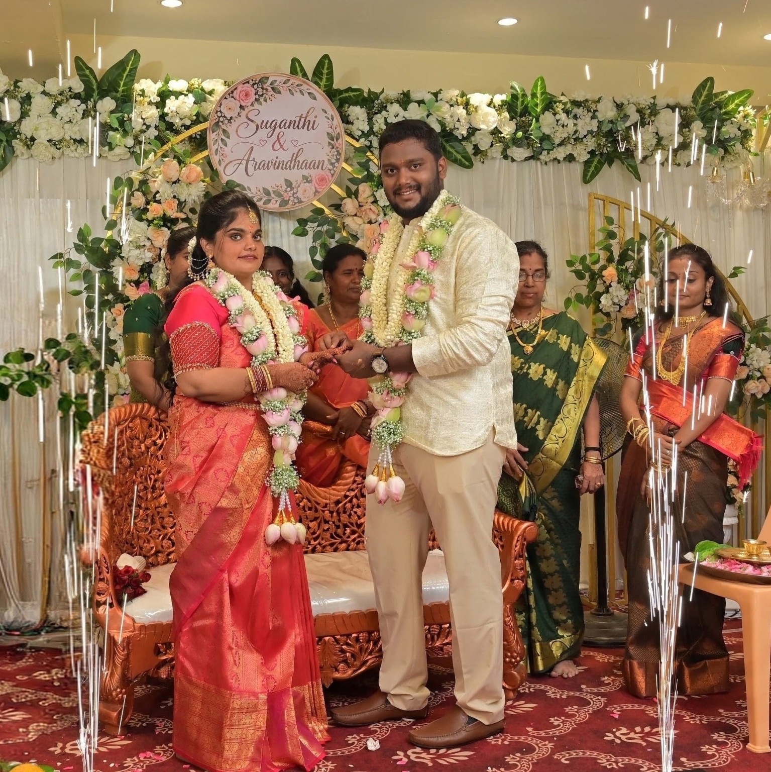 Aravindhaan & Suganthi holding hands during the ring ceremony